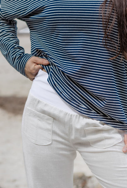 White pants with pockets. Stripy top.